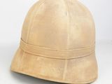 an old helmet on a white surface with a white background