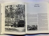an open book with a black and white photo of a train on the tracks