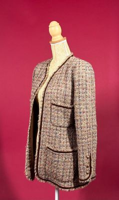 jacket on a mannequin stand against a red background