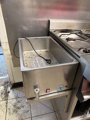 a sink and a stove in a kitchen next to each other