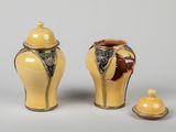 two yellow vases and a small bowl on a white surface