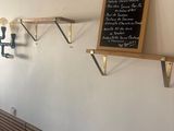 a chalk board on the wall of a coffee shop