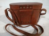 brown leather purse with strap on white background