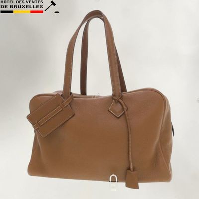 a close up of a brown handbag on a white background