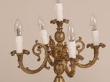 a gold chandelier that has five candles on it