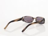 sunglasses on a white surface with a reflection of a pair of glasses