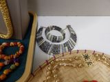 a basket with beads and a necklace on it