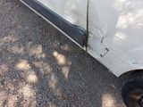 a car that has been damaged and is sitting on the side of the road