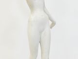 a white statue of a woman standing in a room