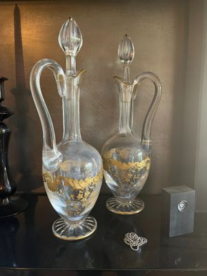 two glass vases sitting on a black table