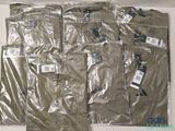 many bags of clothes that are wrapped up on a table