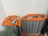 two orange and black trash cans sitting next to each other
