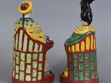 two ceramic figurines of a man and a woman