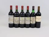 six bottles of wine lined up in a row on a white surface