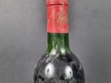 a bottle of wine that has been left on the table