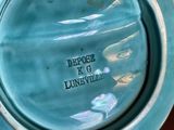 a blue plate with a picture of a woman on it