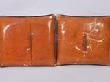 a brown leather case with two zippers on top of it