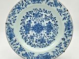 a blue and white plate with a floral design on it