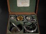 a wooden box with silverware in it on a black background
