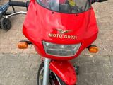 a red motorcycle that is parked on the side of the road