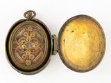 a gold locke with a clock inside of it on a white surface