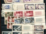 a lot of stamps on the table with a picture of a man