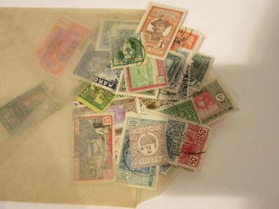 a pile of old postage stamps on a table
