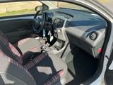 the interior of a small car with a steering wheel and seat covers