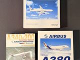 three books on a table with a picture of an airplane