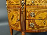 a small chest of drawers with a marble top