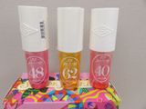 three bottles of lip care sitting on top of a pink box
