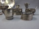 a lot of silver dishes and spoons on a table