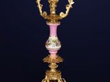 an ornately decorated table with a pink and gold base