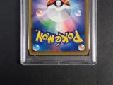 a close up of a pokemon card on a black surface