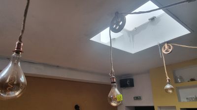 three light bulbs hanging from the ceiling in a room
