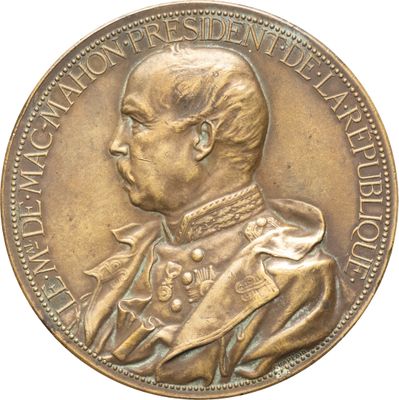 une image représentant une médaille de bronze sur laquelle figure le portrait d'un homme