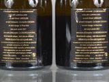 two bottles of wine that are sitting on a table
