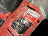 a close up of a red and black tool on a table