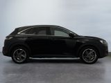 the black suv is parked in a room with a white wall
