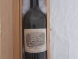 a bottle of wine in a wooden box on a table