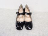 pair of black women ' s shoes with buckles on a white surface