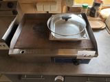 a pan sitting on top of a stove in a kitchen