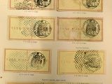 un vieux livre sur lequel sont collés plusieurs timbres