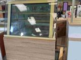 a wooden pallet with a glass display case on it