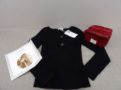 a black jacket and a red purse on a bed