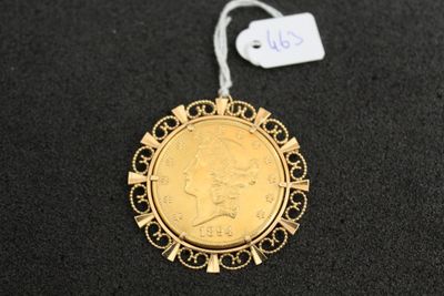 a close up of a gold coin with a tag on it