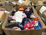 many boxes of clothes that are sitting on the floor