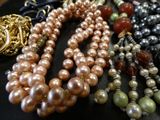 a lot of pearls and other jewelry on a table