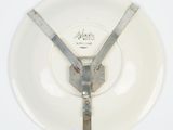 a white plate with a metal handle and a white plate with a white plate underneath it