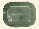 a green plate with a silver handle on it